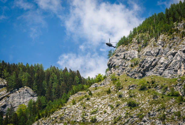 Army helicopter preforming a rescue in the mountains.