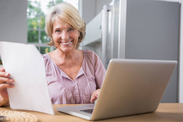 istock Happy mature woman using her laptop 849782160