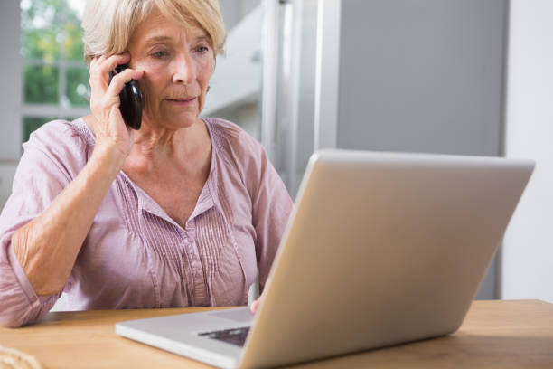 istock Focused woman using her laptop and calling 849782226
