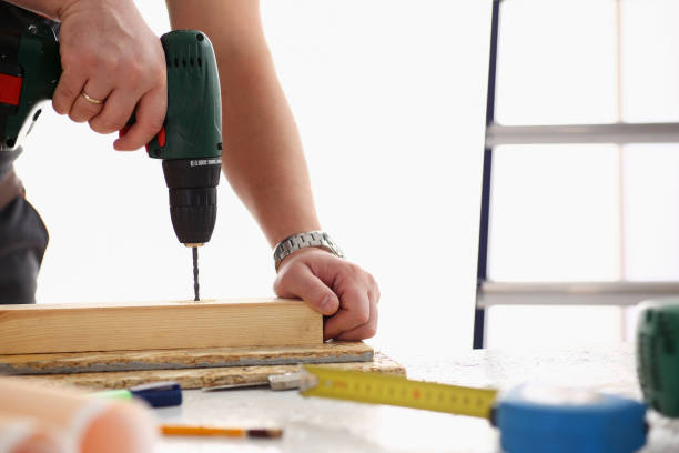 istock Arms of worker using electric drill closeup 849782426
