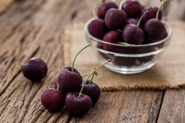 istock red cherry on wooden background 849789016