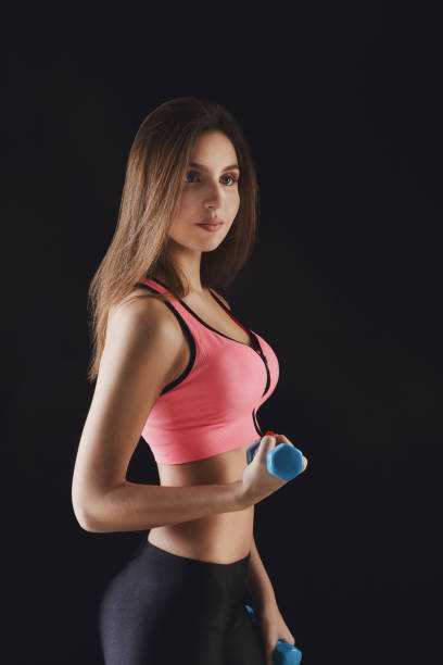 istock Fitness model woman with dumbbells at studio 849789090