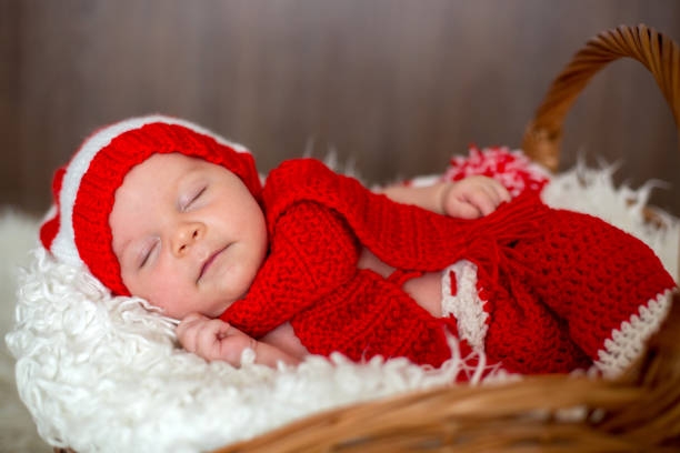 istock Little sleeping newborn baby boy, wearing Santa hat 849789300
