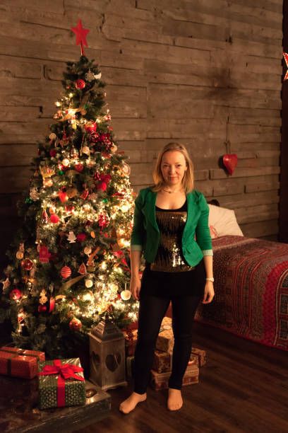 istock Woman is standing near Christmas tree 849789486