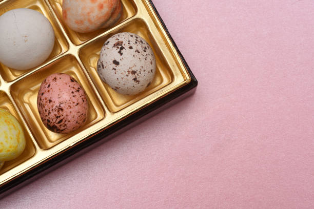 istock colored chocolate balls on pink paper background 849790772