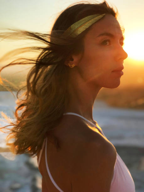 istock Beautiful woman at gold sunset light 849801540