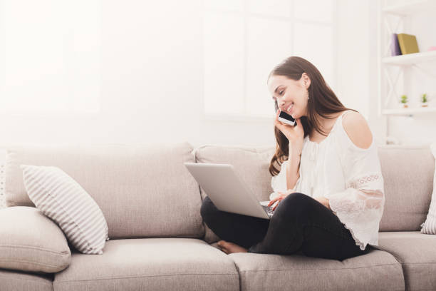 istock Girl at home with laptop and mobile 849802534