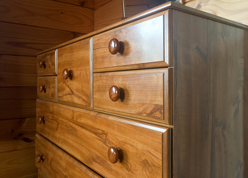 Brown wooden tallboy chest of drawers