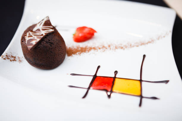 Macaroons with fresh fruit on chocolate cake