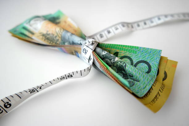 istock Tape measure tightly wrap Australian banknotes 849819582