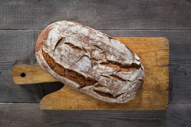 istock Baked bread on wooden background 849821982