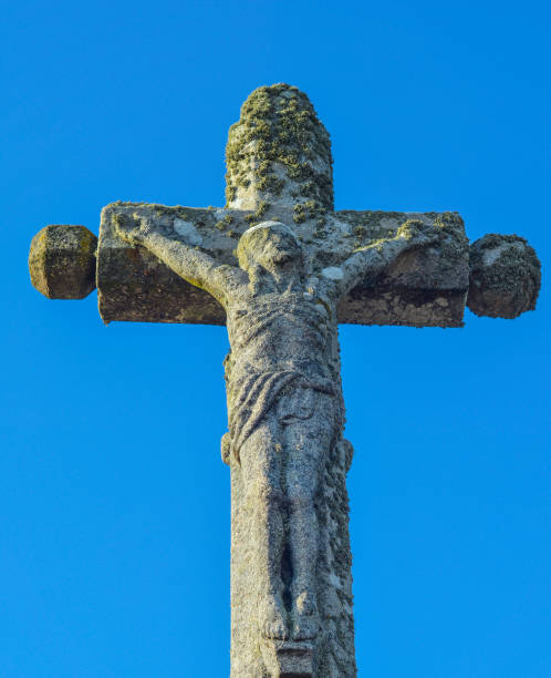 istock stone cross with crucified Jesus Christ 849822514