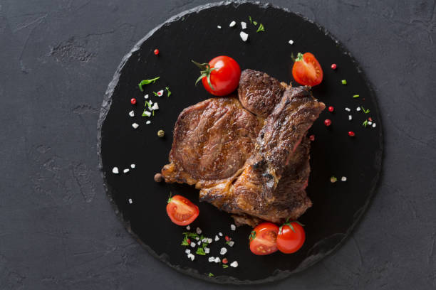 istock Rib eye steak on dark plate, top view 849822720