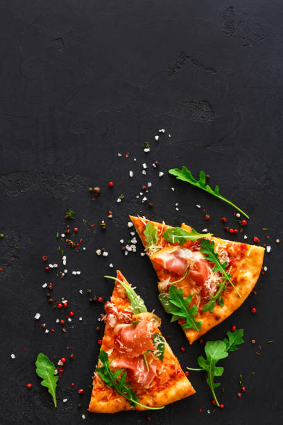 istock Pizza with prosciutto and rocket salad copy space 849829262