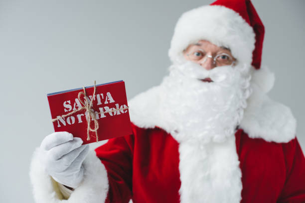 istock santa claus holding letters 849829430