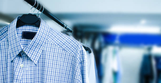 Several ironed mens shirts in a wardrobe