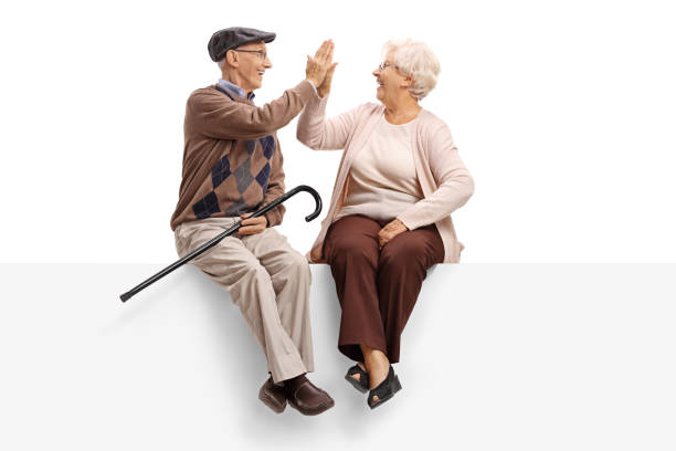 istock Seniors seated on a panel high-fiving each other 849837392