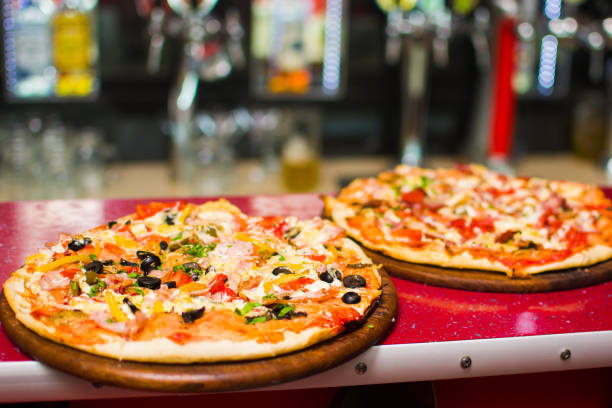 istock pizza on a wooden substrate in a pizzeria 849837560