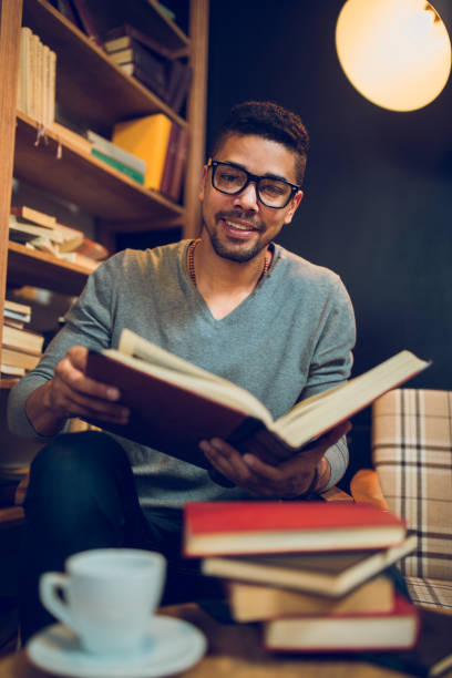 istock Smiling African American student  enjoying book reading in library 849838434