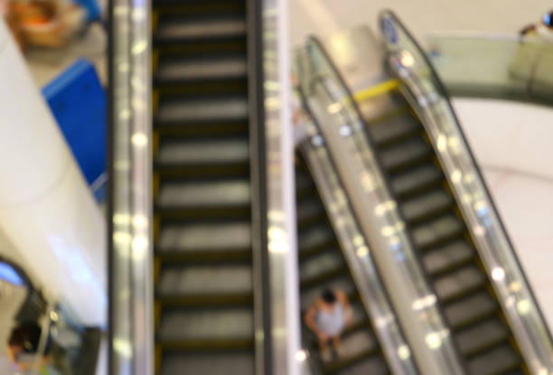 istock Abstract blurred of the escalators with people going down in a shopping mall 849838568