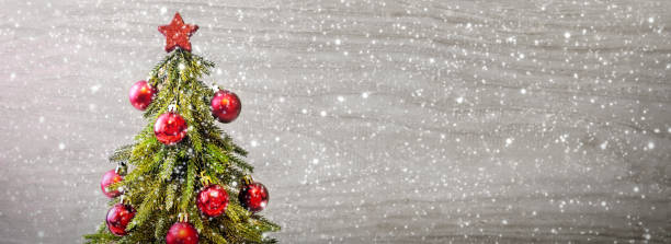 istock Christmas tree with red balls and snowfall 849841082