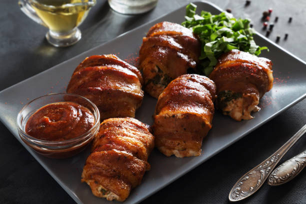 istock Stuffed chicken breasts rolled in bacon with ketchup 849841894