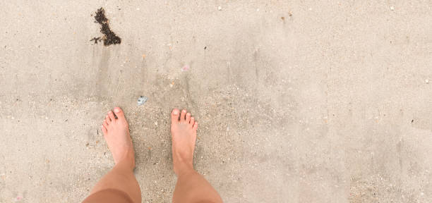istock Female feet on beach 849845508