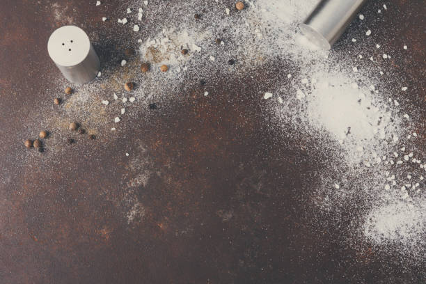 istock Scattered salt and pepper on dark background 849845776