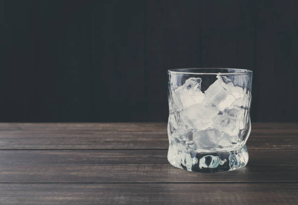 istock Glass with ice cubes on dark background 849846326