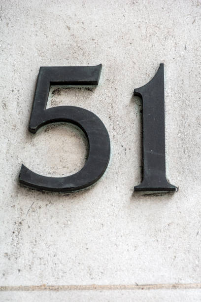 istock Number fifty one in dark figures on white wall 849847438