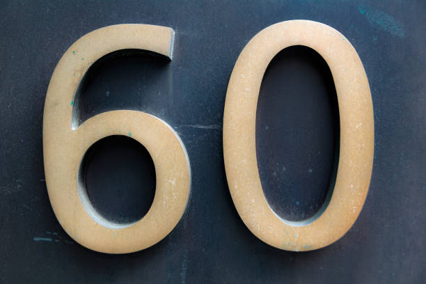 istock Elegant number sixty in soft gold on dark background 849850244