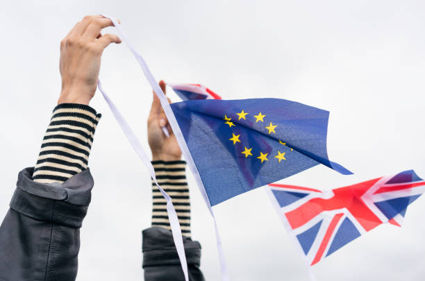 istock Brexit - Holding EU and UK Flags 849850290
