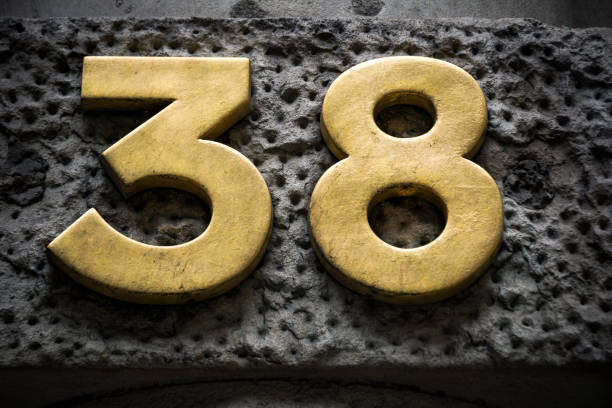istock Golden number thirty eight on dark wall 849850698