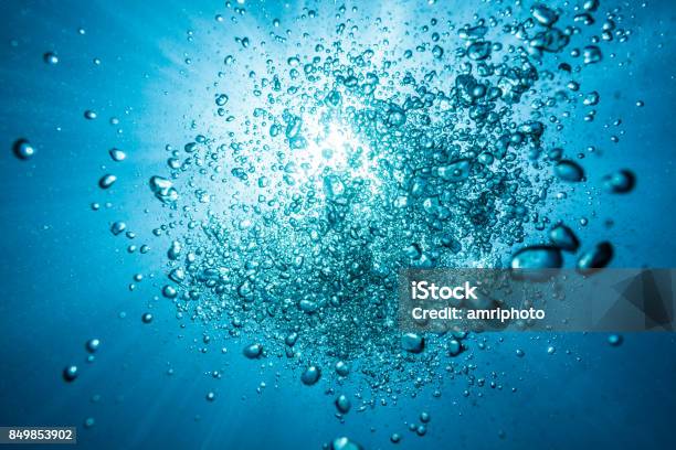 Diving Bubbles Underwater Against Surface With Sunlight Stock Photo - Download Image Now