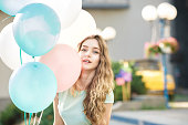 beautiful woman with flying multicolored balloons