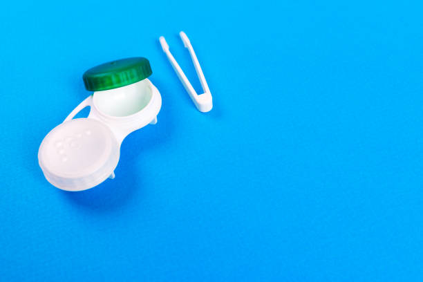 istock Containers for contact lenses, tweezers on blue background 849858634