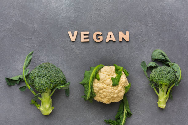istock Vegan. Fresh broccoli and cauliflower on gray background, top view 849858750