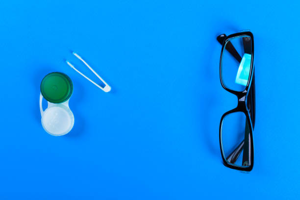 istock Contact lenses set with plastic case and tweezers with glasses on the background plan on a lilac background. How to store and use contact lenses 849858776