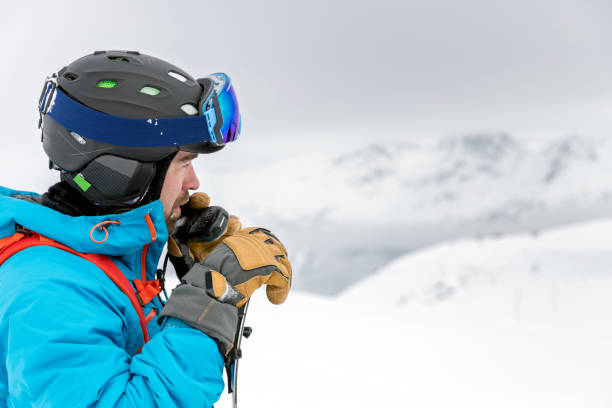 Skier Snowboarder Using Walkie Talkie in Backcountry Area Skier Snowboarder Using Walkie Talkie in Backcountry Area ski patrol photos stock pictures, royalty-free photos & images
