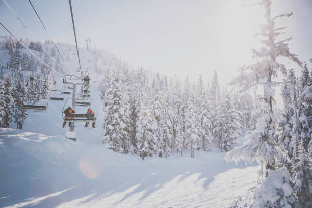 Ski Chair Lift at Whistler Blackcomb Ski Resort People going up in Ski Chair Lift at Whistler Blackcomb Ski Resort whistler mountain stock pictures, royalty-free photos & images