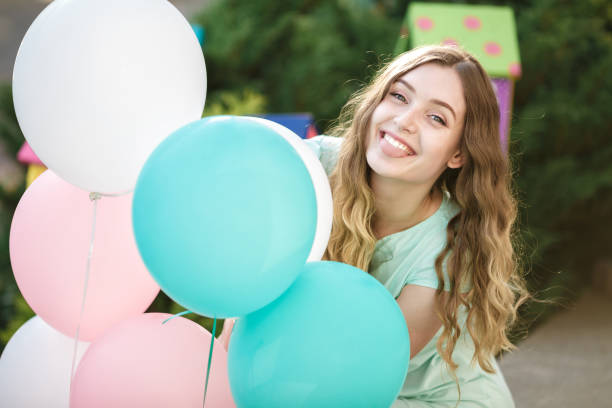 istock beautiful woman with flying multicolored balloons 849863894