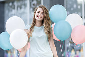 beautiful woman with flying multicolored balloons