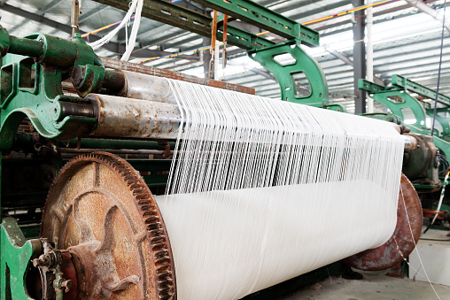 weaving machine produce white cloth.Blue tone map.
