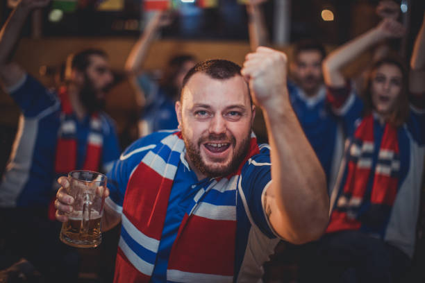 istock Friends drinking beer and watching game in bar 849882022