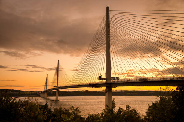 Queensferry Crossing Suspension Bridge Across Forth of Fife Queensferry Crossing, the third ground transportation bridge crossing the Firth of Forth and linking Midlothian and Fife. The elegant cable-stayed bridge was opened on 4 September 2017. Shot at sunset from the Fife side. midlothian scotland stock pictures, royalty-free photos & images