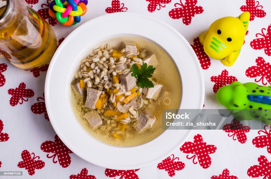 Soup with pearl barley Soup with pearl barley and meat for baby food. Selective focus. Backgrounds Stock Photo