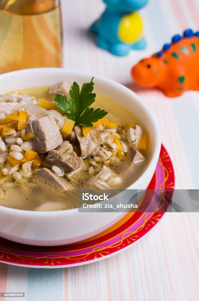 Soup with pearl barley Soup with pearl barley and meat for baby food. Selective focus. Backgrounds Stock Photo