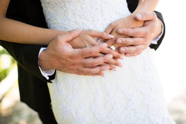 istock Young man gently embraces his bride in a wedding dress. 849890048