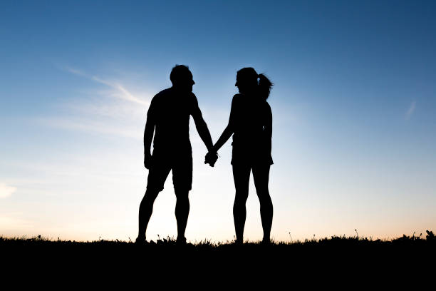 istock silhouette of romantic lovers with sunset on the back 849897630