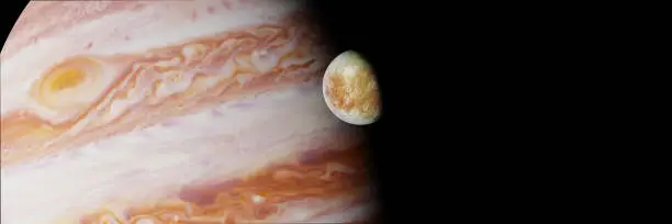 Photo of Jupiter's moon Europa in front of the planet Jupiter